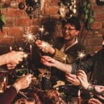 Family celebrating New Year holiday with festive dinner at home